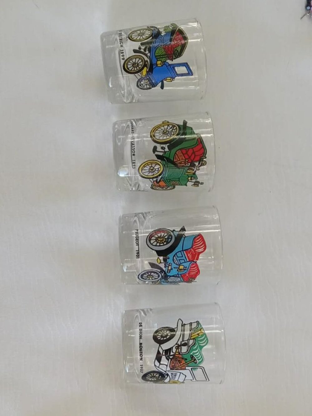 Collection of 4 vintage small glasses with a heavy base and old car designs